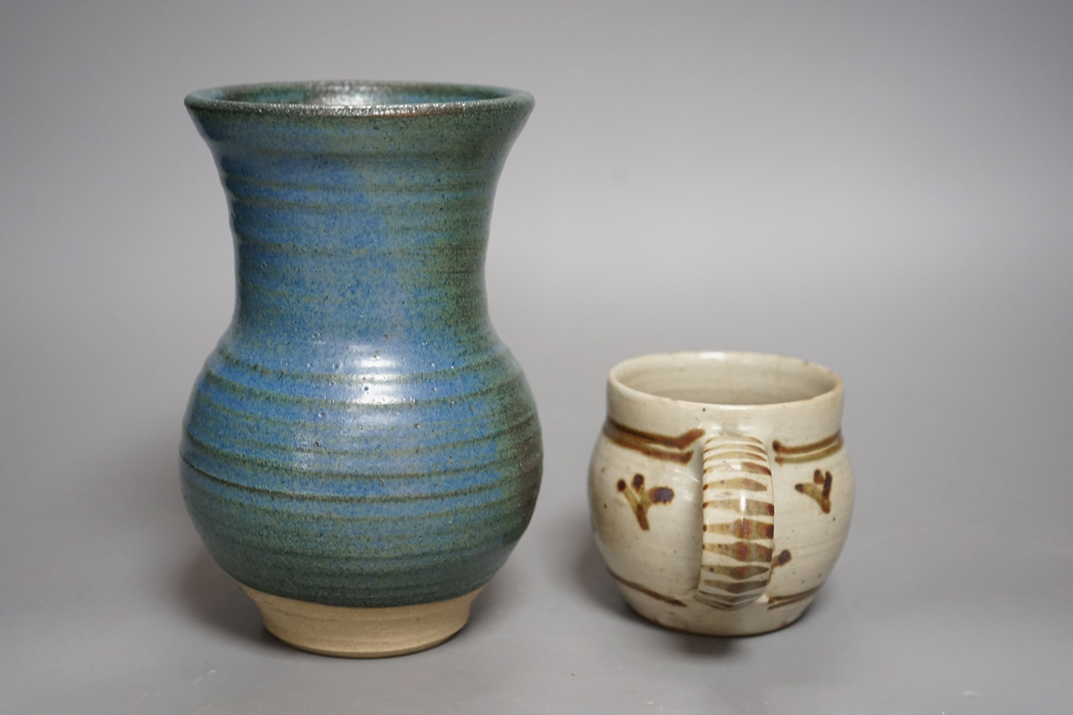 An Accolay style blue glazed stripe vase, together with a Wenford Bridge stoneware mug, both with impressed marks, tallest 19cm, (2)